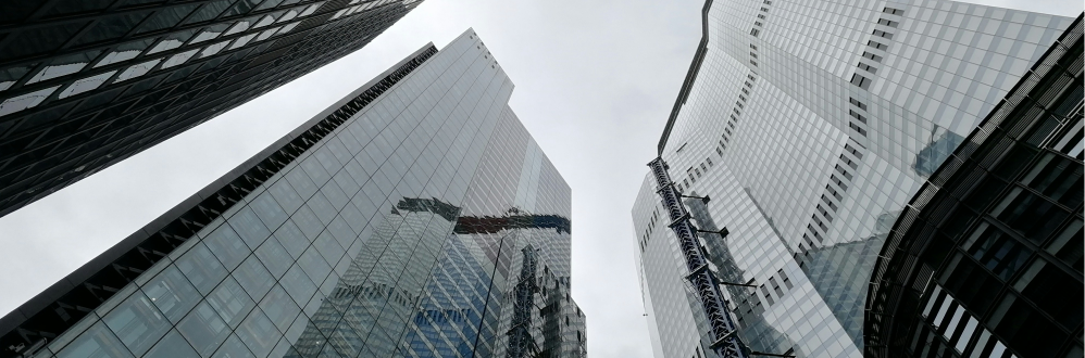 Looking up at london skyscrapers against a grey sky