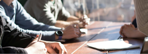 Hands around a meeting table